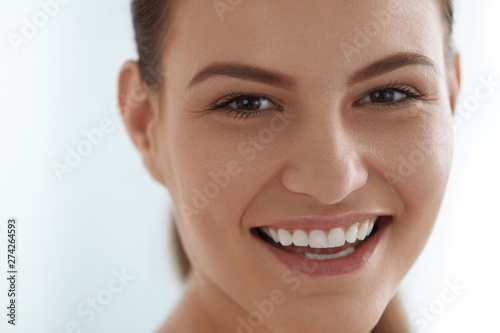 Smiling woman face with white teeth smile  clean skin portrait