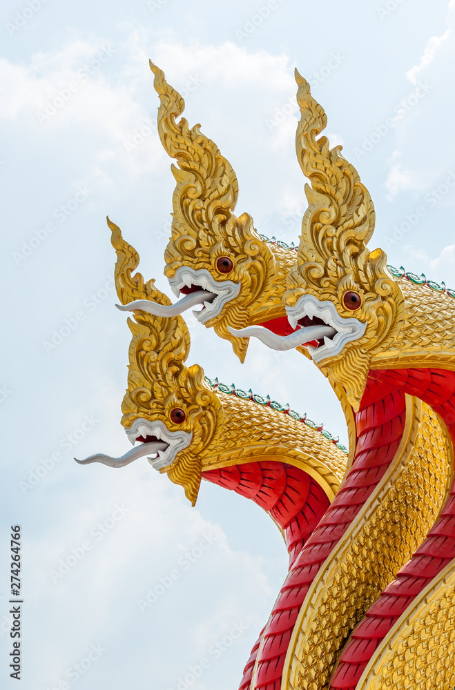 Fototapeta premium Golden serpent sculpture in the traditional Thai style.