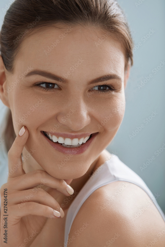 Smiling woman face with white teeth smile, clean skin portrait Smiling woman face with white teeth smile, clean skin portrait