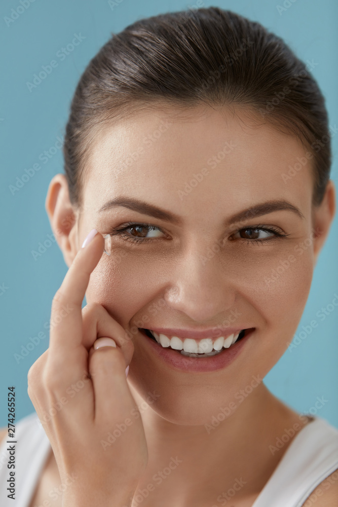 Contact eye lens. Smiling woman applying eye contacts closeup Contact eye lens. Smiling woman applying eye contacts closeup