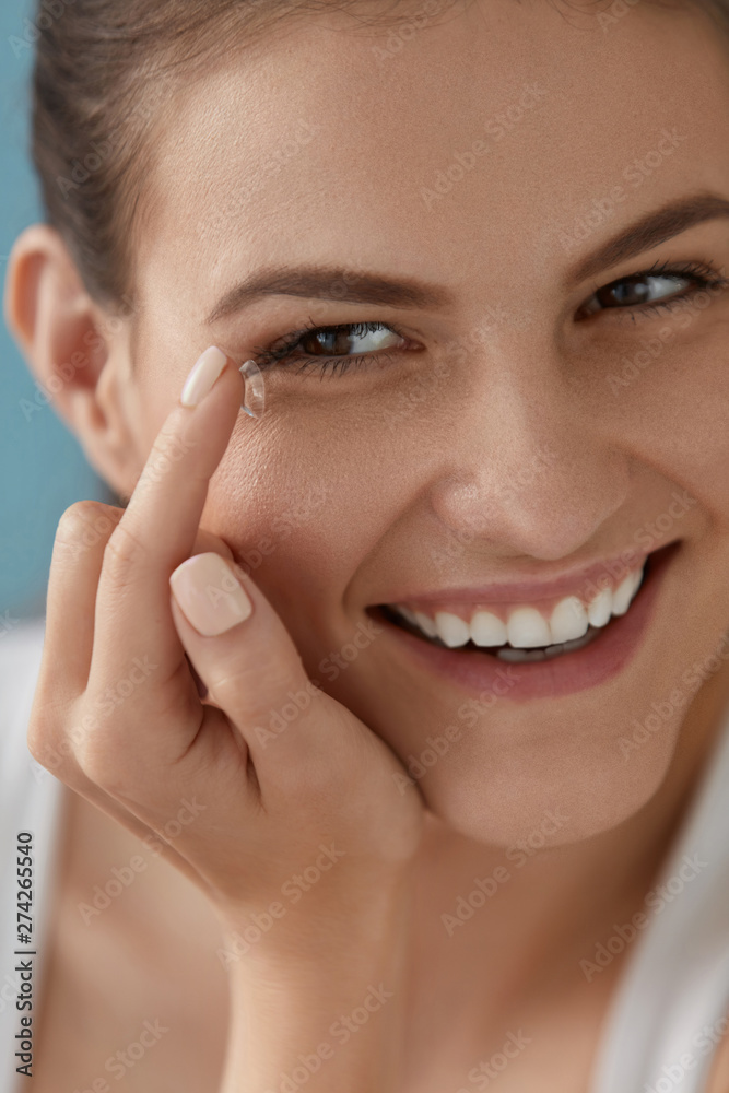 Contact eye lens. Smiling woman applying eye contacts closeup Contact eye lens. Smiling woman applying eye contacts closeup