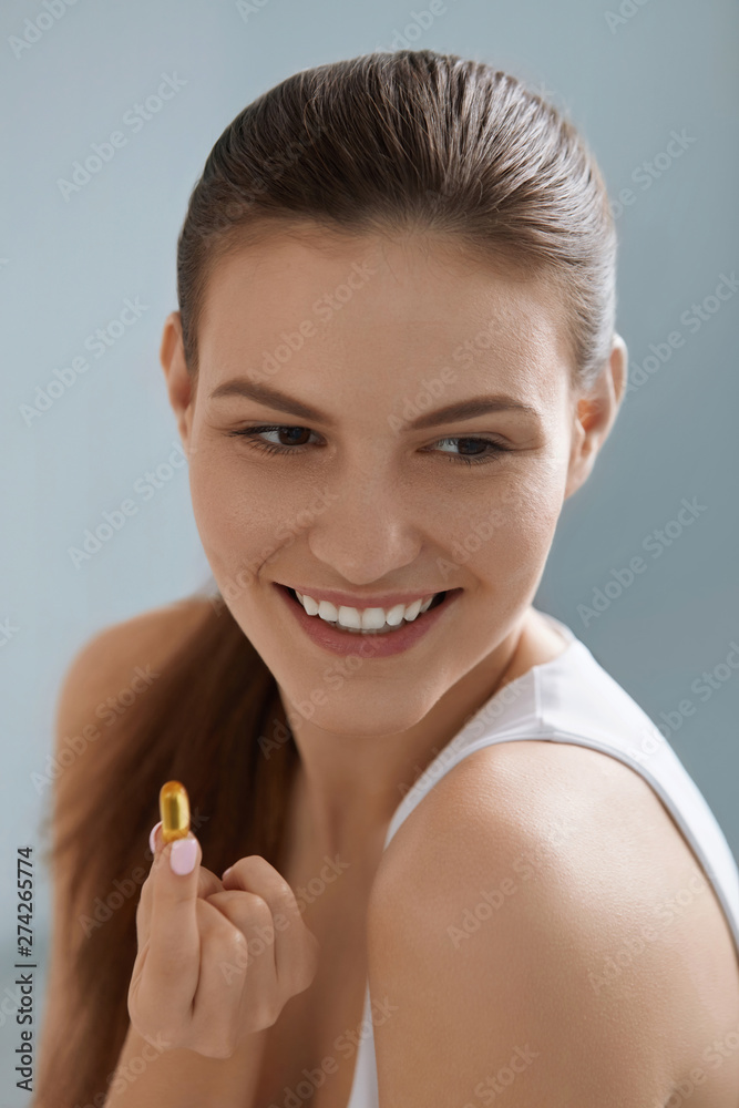 Vitamin. Smiling woman with omega 3 pill, fish oil capsule Vitamin. Smiling woman with omega 3 pill, fish oil capsule