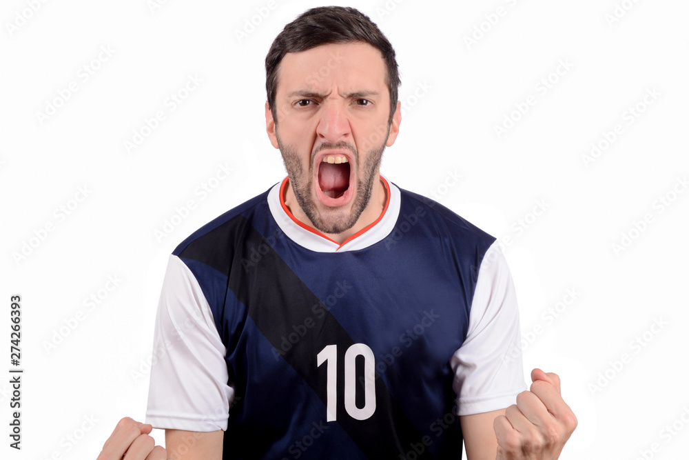 Young man in soccer football uniform screaming while his team win.