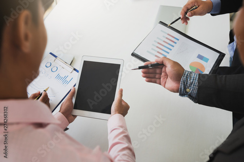 Businessmen discussing together in meeting room. Businessman using Tablet in conference. Professional investor working with business project together.
