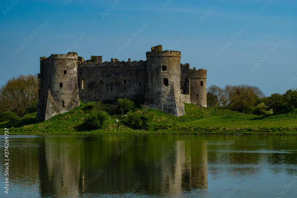 castle on the side of a lake