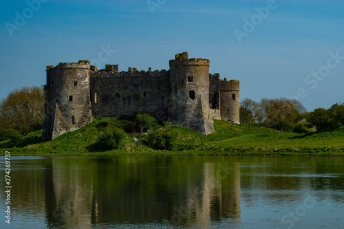 castle on the side of a lake