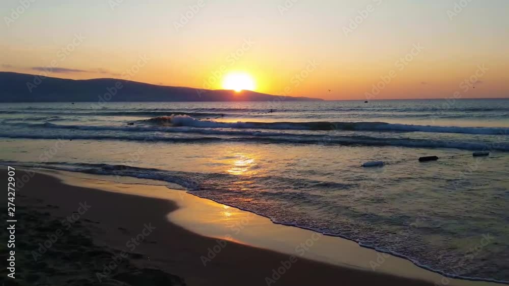 Beautiful sunset by the sea. Small waves and clear sky. Beautiful sunset by the sea. Small waves and clear sky.