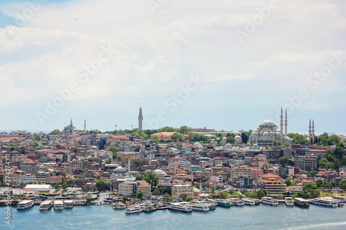 Eminönü skyline in Istanbul, view of architecture and ships on a golden horn and mosque Suleymaniye