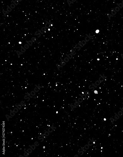 falling snow at night. snowfall at night. white chaotic spots on a black background