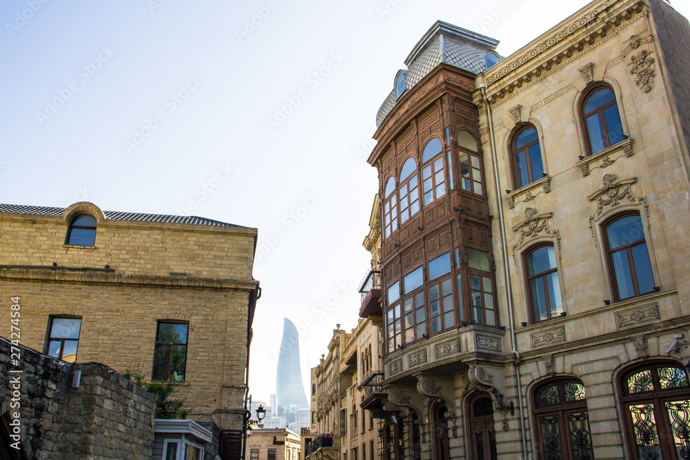 Architecture of the old city in Baku on the background Flame Towers
