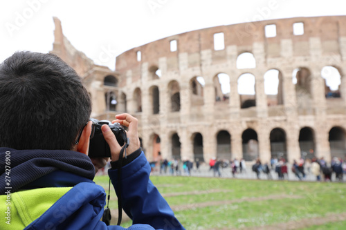 photographer taking a picture of the Roman Colosseum amphitheate photo