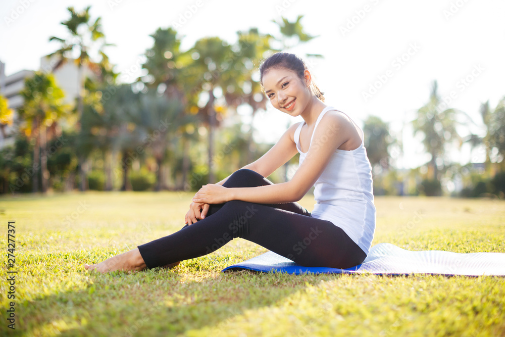 Woman on a yoga mat to relax outdoor. Woman on a yoga mat to relax outdoor.