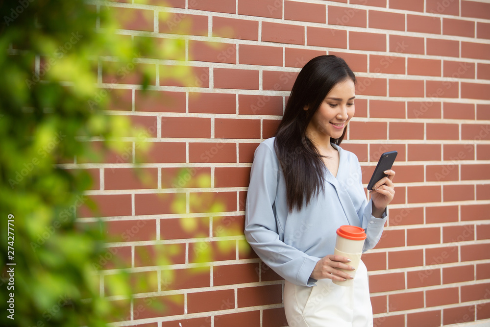 Professional business woman using technology outside, Professional female manager reading information in internet while walking outdoor Professional business woman using technology outside, Professional female manager reading information in internet while walking outdoor