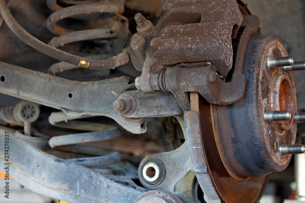 car disc brakes and visible shock absorbers without wheel car disc brakes and visible shock absorbers without wheel