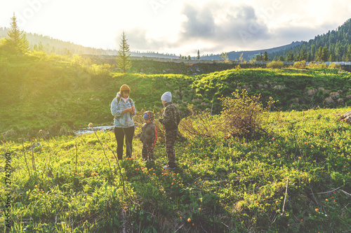 mom and sons in field