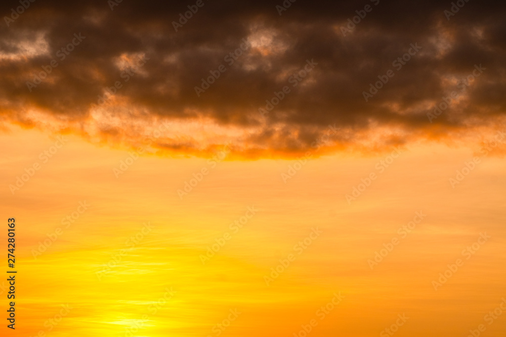Golden cloudy sky with dark texture cloud backgroun in twilight 