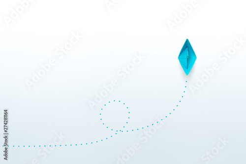 Fototapeta Naklejka Na Ścianę i Meble -  Blue paper ship on white background, Leadership, Business successful concept. copy space