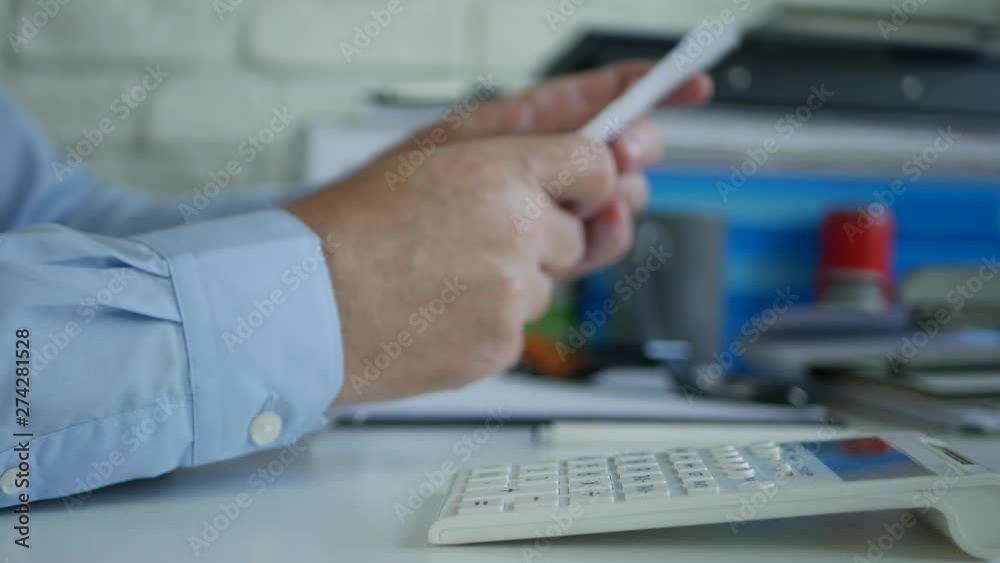 Businessman in Accounting Office Calculate Bills Using Adding Machine Businessman in Accounting Office Calculate Bills Using Adding Machine