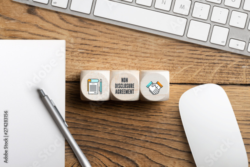 Obraz na plátně Cubes with acronym NDA for non disclosure agreement on wooden background