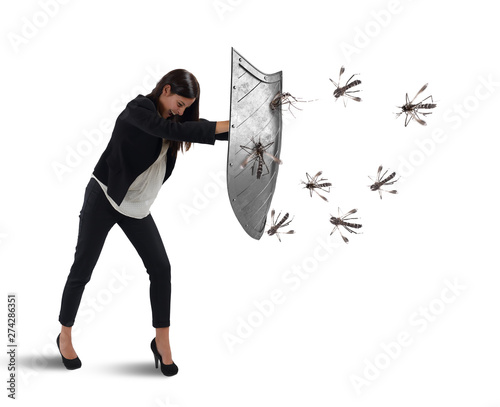 Woman defends herself from the attack of mosquitoes with a shield photo