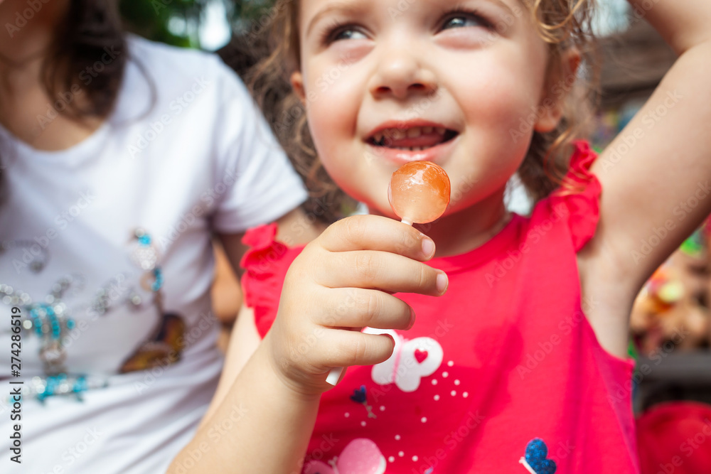 Little girl holding in hand a lollipop Little girl holding in hand a lollipop