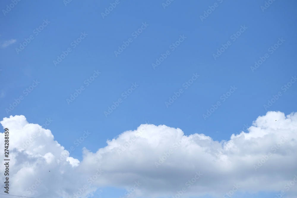 Blue sky with white fluffy clouds in bright day for background texture Blue sky with white fluffy clouds in bright day for background texture