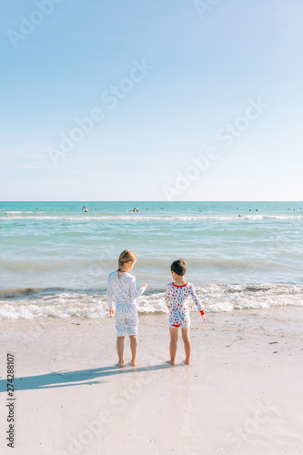 Brother and Sister Walking on Beach