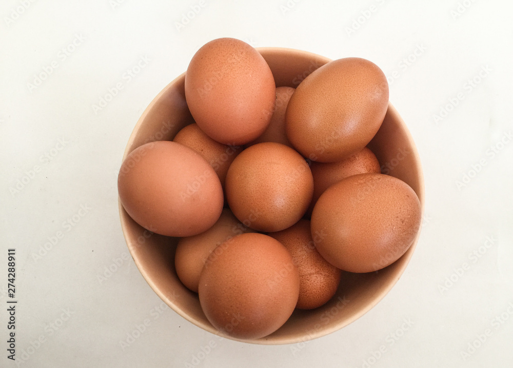 Eggs: brown eggs in separate cups on a white background in close-up shot from top to bottom Thailand Eggs: brown eggs in separate cups on a white background in close-up shot from top to bottom Thailand