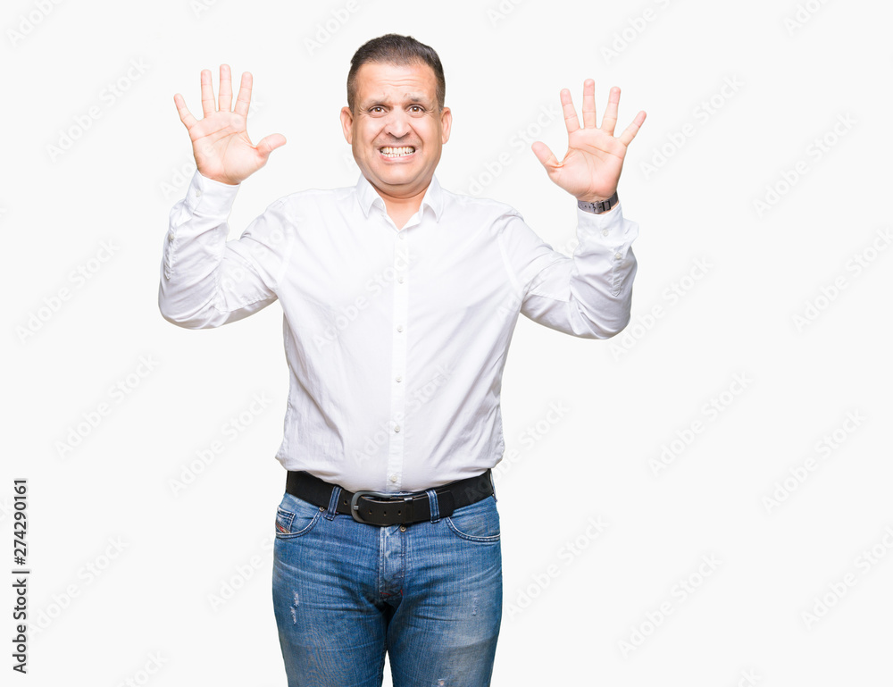 Middle age arab elegant man over isolated background showing and pointing up with fingers number ten while smiling confident and happy. Middle age arab elegant man over isolated background showing and pointing up with fingers number ten while smiling confident and happy.