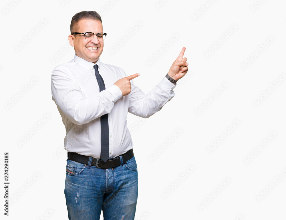 Middle age bussines arab man wearing glasses over isolated background smiling and looking at the camera pointing with two hands and fingers to the side. Middle age bussines arab man wearing glasses over isolated background smiling and looking at the camera pointing with two hands and fingers to the side.