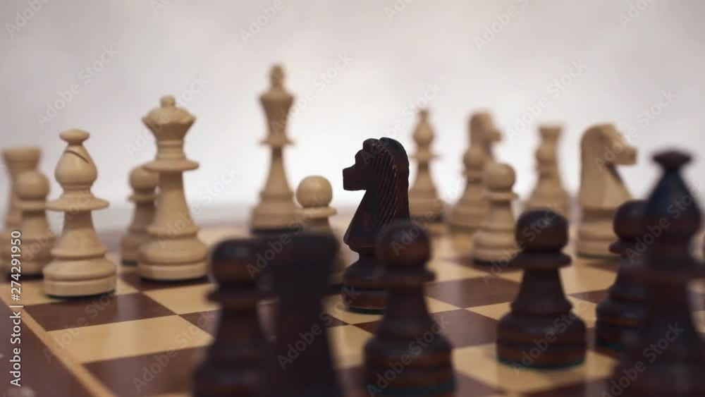 Chess knight in center board. Close-up. Circular movement of the camera, dolly shot. Chess knight in center board. Close-up. Circular movement of the camera, dolly shot.