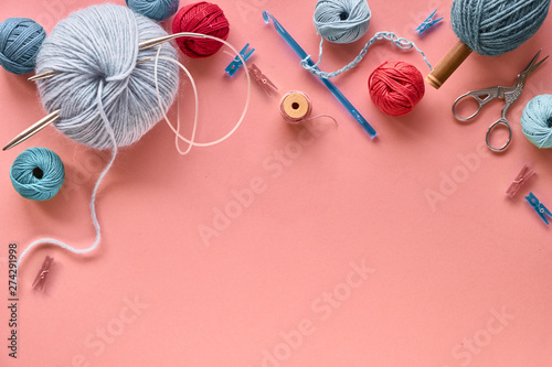 Various wool yarn and knitting needles, creative knitting hobby background with text space photo