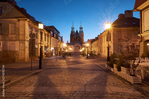 Gniezno in Poland, evening view of street in Old Town with The Royal Gniezno Cathedral behind
