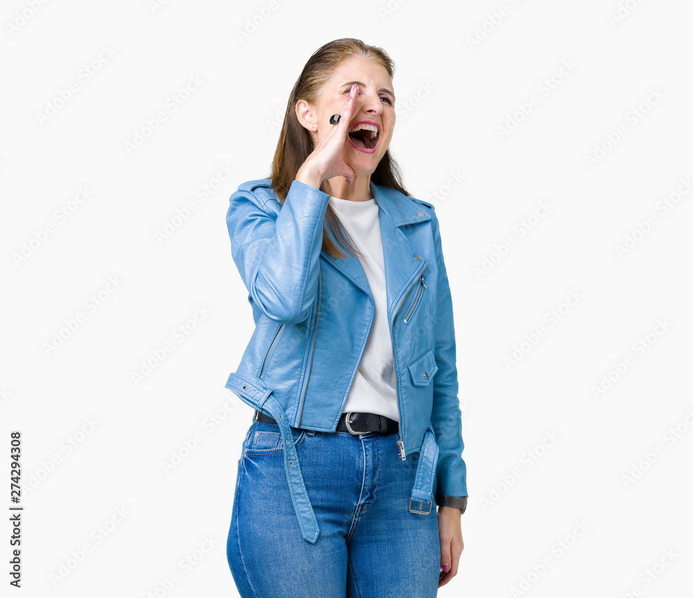 Beautiful middle age mature woman wearing fashion leather jacket over isolated background shouting and screaming loud to side with hand on mouth. Communication concept. Beautiful middle age mature woman wearing fashion leather jacket over isolated background shouting and screaming loud to side with hand on mouth. Communication concept.