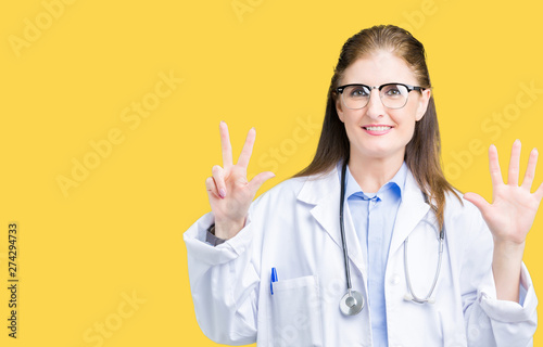 Middle age mature doctor woman wearing medical coat over isolated background showing and pointing up with fingers number eight while smiling confident and happy.