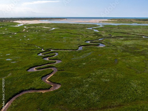 Aerial image of dutch national park with curving rivers in grass land towards the north sea on the island of Texel