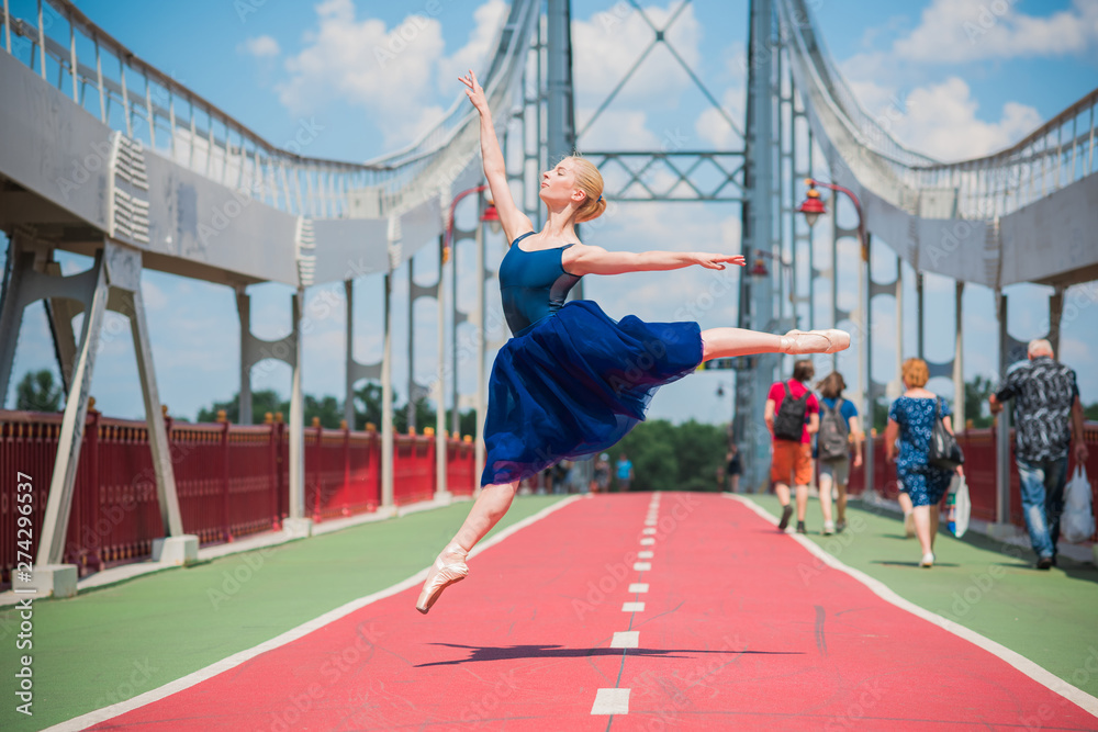 Young ballerina in ballet costume dancing in city , feeling breath of ...