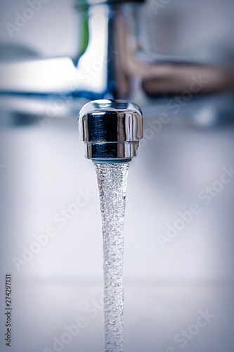 water flows from the kitchen tap, close-up.