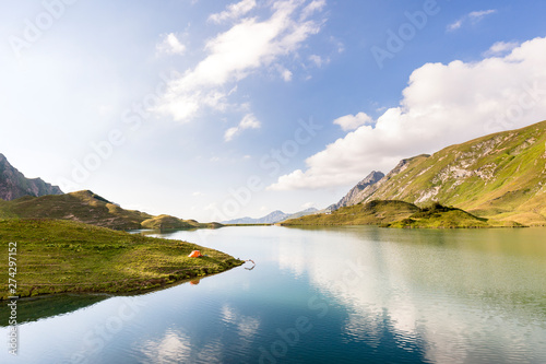 Allg‰u, Bavaria, Germany: A male backpacker plunging into the cold water of a lake. photo