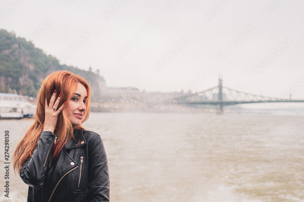 Tourism in Europe, vacation concept. Beautiful woman look at view of city streets, centre of city. Trip in Budapest Tourism in Europe, vacation concept. Beautiful woman look at view of city streets, centre of city. Trip in Budapest