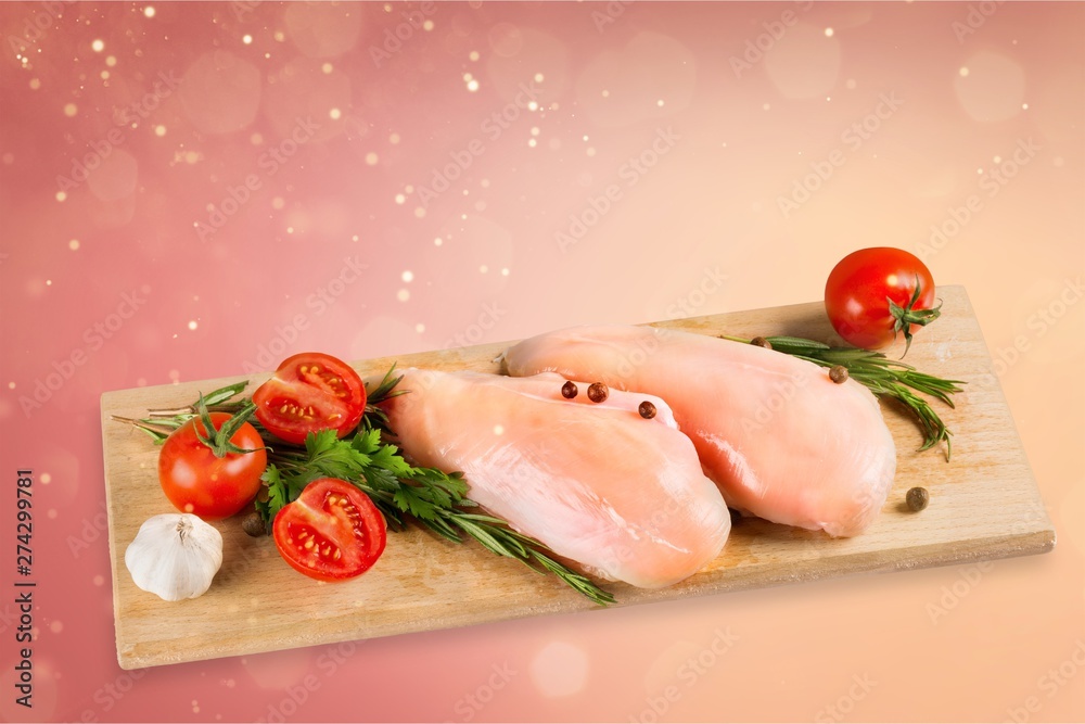 Raw turkey breasts with vegetables, spice and herbs on wooden cutting boardRaw turkey breast with tomatoes and garlic on cutting board Raw turkey breasts with vegetables, spice and herbs on wooden cutting boardRaw turkey breast with tomatoes and garlic on cutting board