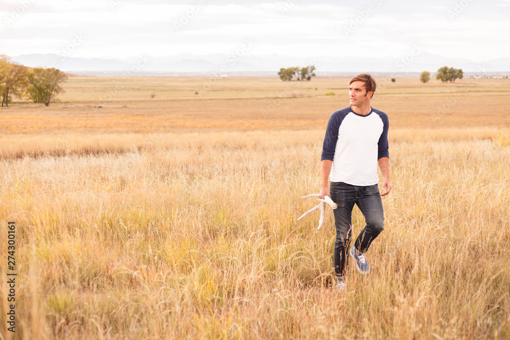 Denver, Colorado, USA: A man with after finding an antler at the Rocky Mountain Arsenal National Wildlife Refuge. Denver, Colorado, USA: A man with after finding an antler at the Rocky Mountain Arsenal National Wildlife Refuge.