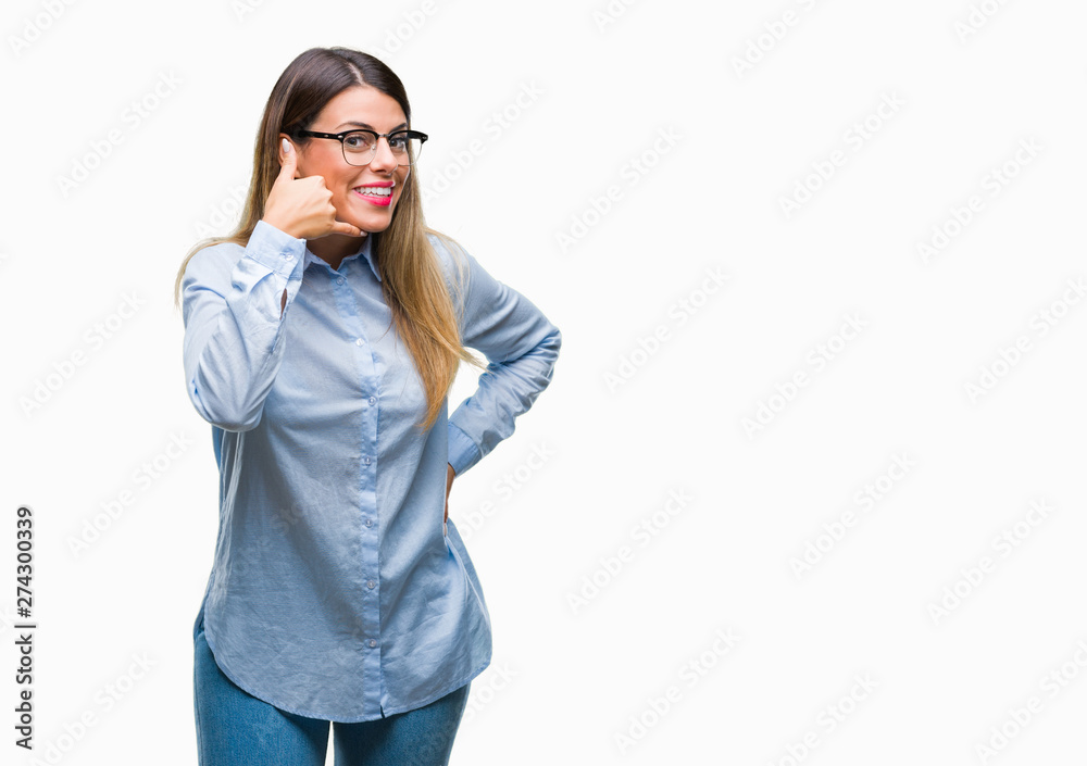Young beautiful business woman wearing glasses over isolated background smiling doing phone gesture with hand and fingers like talking on the telephone. Communicating concepts. Young beautiful business woman wearing glasses over isolated background smiling doing phone gesture with hand and fingers like talking on the telephone. Communicating concepts.