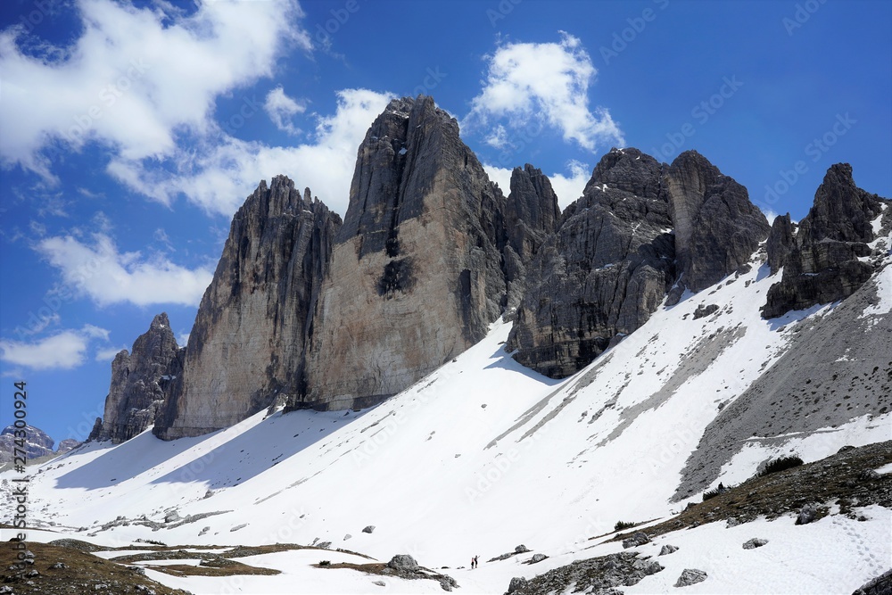 The peaks of tre Cime di Lavaredo, blue sky and a lot of snow, Dolomites, Italy, June 