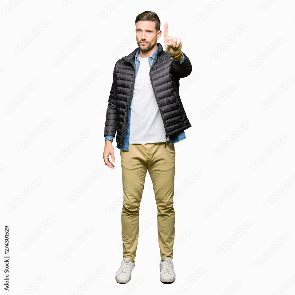 Handsome man wearing winter coat Pointing with finger up and angry expression Handsome man wearing winter coat Pointing with finger up and angry expression