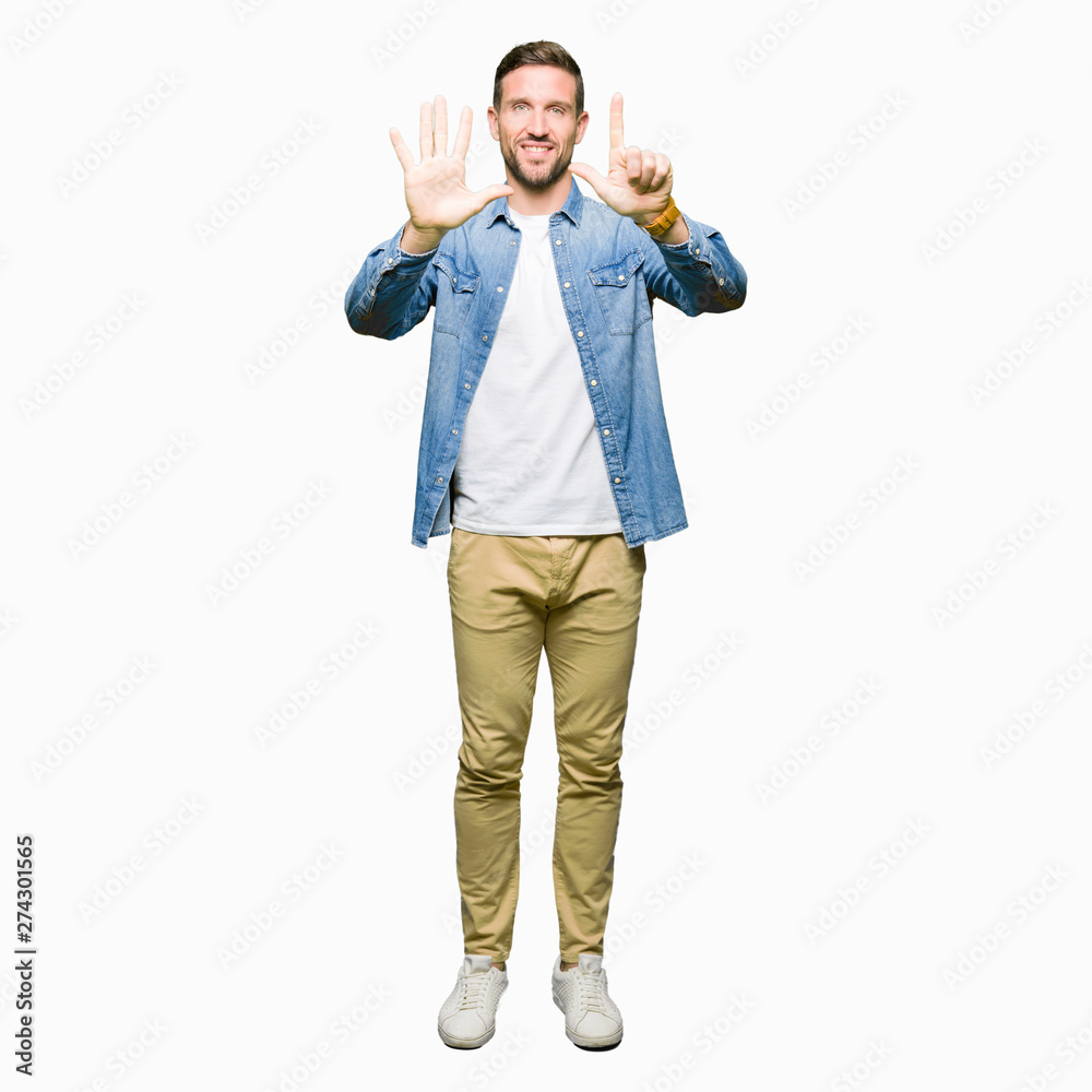 Handsome man with blue eyes and beard wearing denim jacket showing and pointing up with fingers number seven while smiling confident and happy.