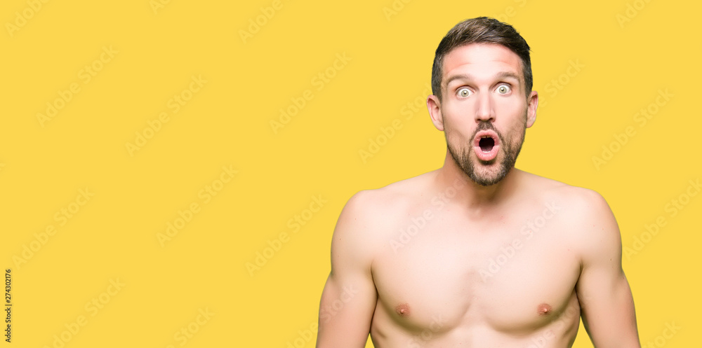 Handsome shirtless man showing nude chest afraid and shocked with surprise expression, fear and excited face. Handsome shirtless man showing nude chest afraid and shocked with surprise expression, fear and excited face.