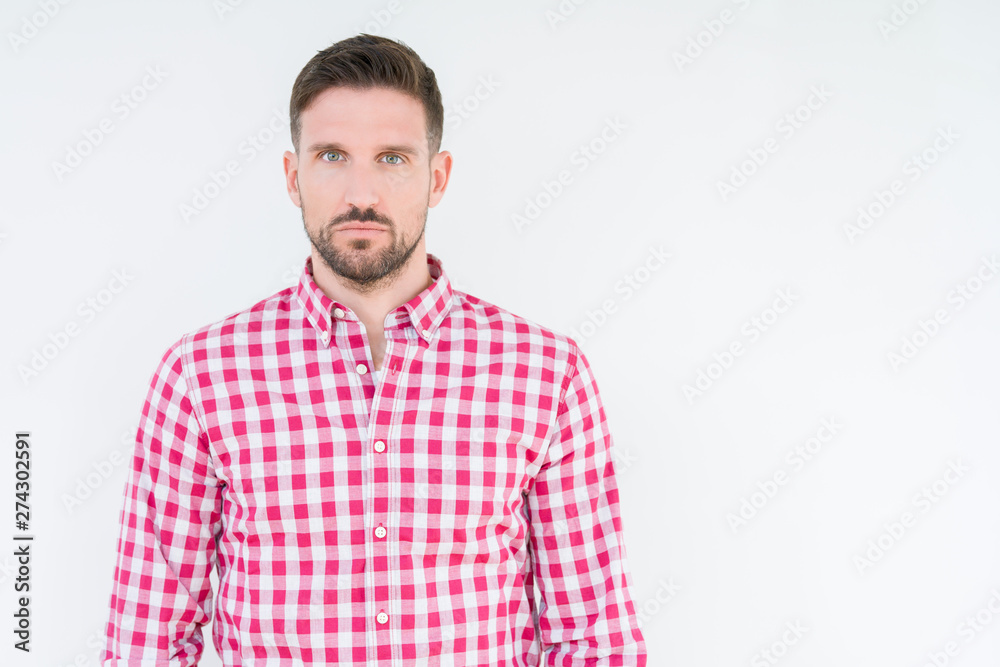 Fototapeta premium Young handsome man wearing shirt over isolated background Relaxed with serious expression on face. Simple and natural looking at the camera.