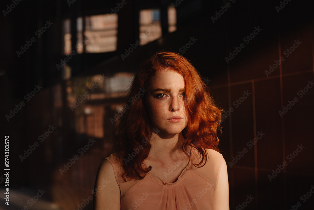 Portrait of young sad woman standing in passageway in city Portrait of young sad woman standing in passageway in city