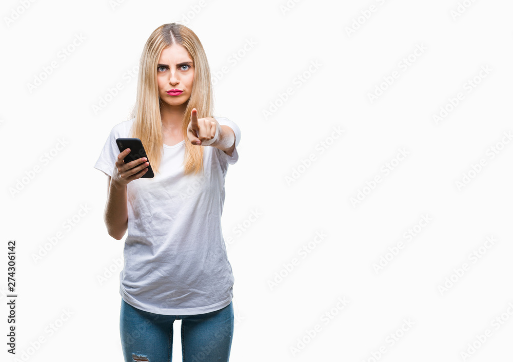 Young beautiful blonde woman using smartphone over isolated background pointing with finger to the camera and to you, hand sign, positive and confident gesture from the front Young beautiful blonde woman using smartphone over isolated background pointing with finger to the camera and to you, hand sign, positive and confident gesture from the front